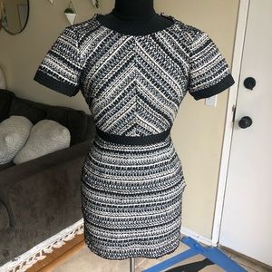 Tweed dress. Black, gold & white. Zips in the back. Has pockets & extra button.